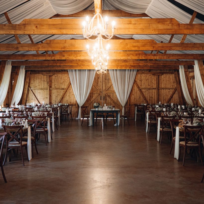 Cheerful wedding reception taking place in a rustic barn setting. Cheerful wedding reception taking place in a rustic barn setting.